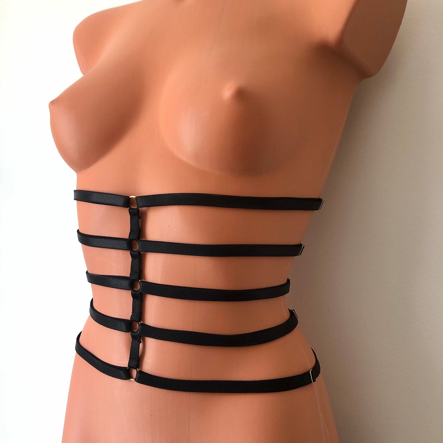 Black elastic waist cage harness on a mannequin - front diagonal