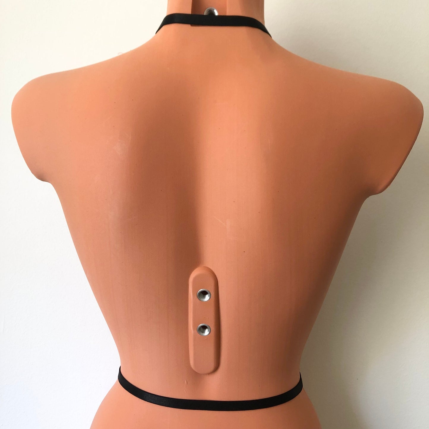 An elastic chest harness on a mannequin - back