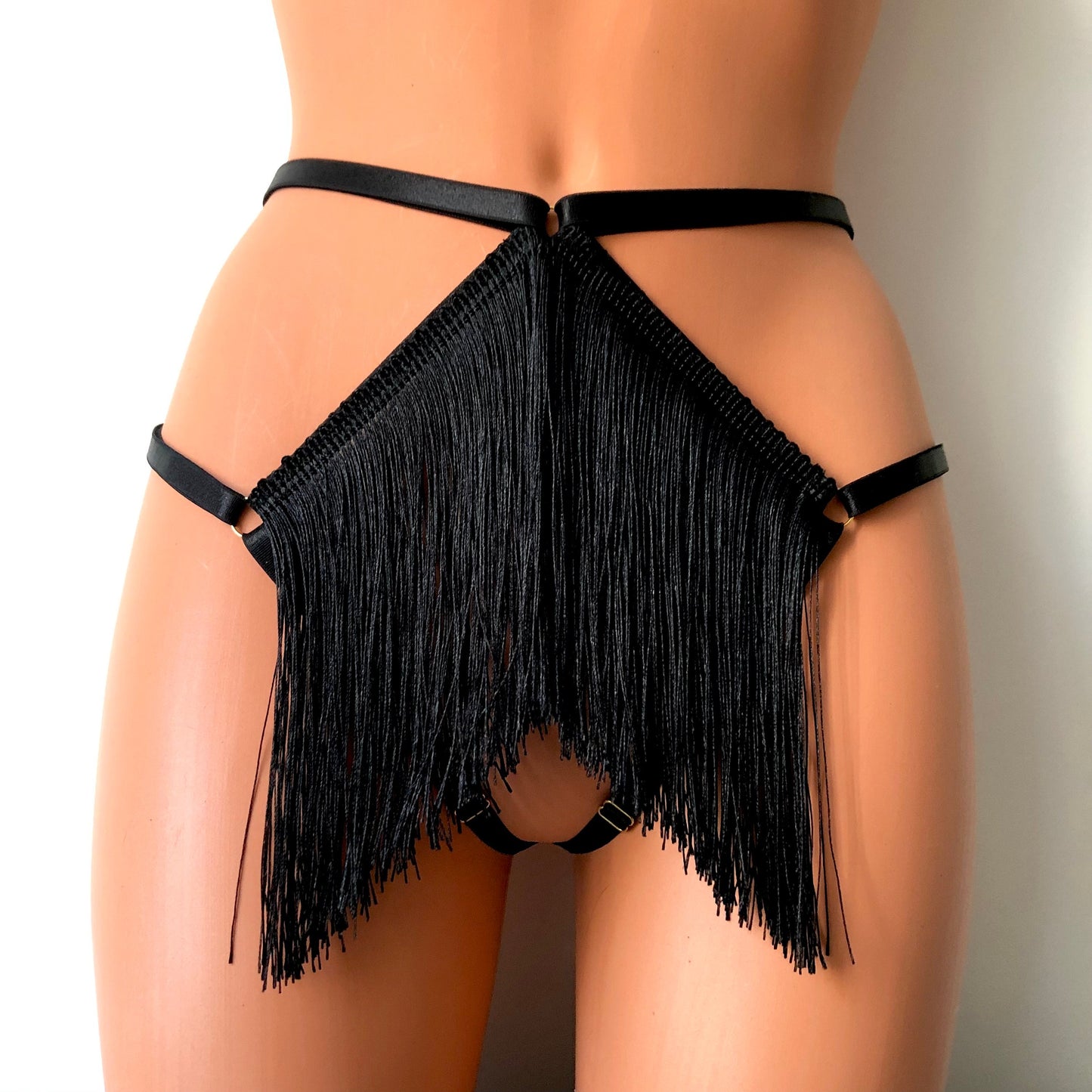 Black shimmy fringe cage thong on a mannequin - front