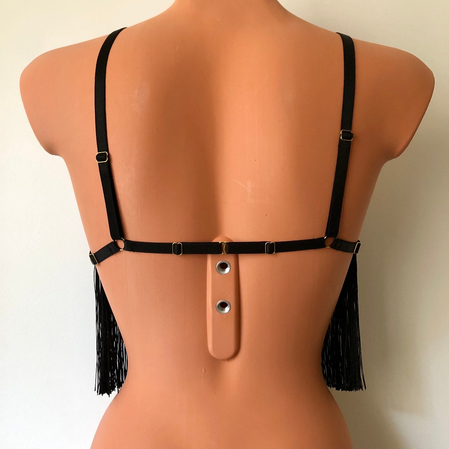 Black shimmy fringe cupless bra on a mannequin - back