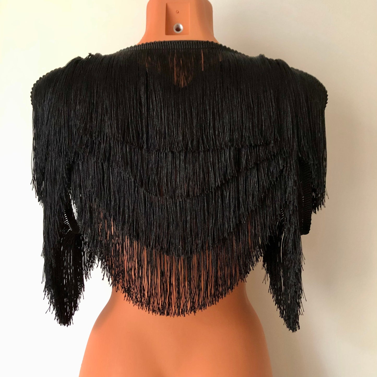 Black shimmy fringe shrug bolero capelet on a mannequin - back