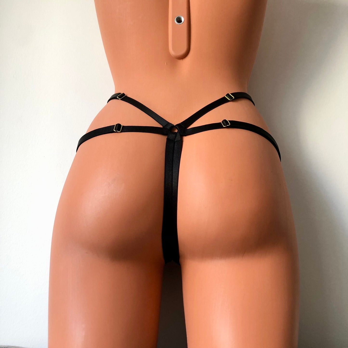 Black shimmy fringe cage thong on a mannequin - back