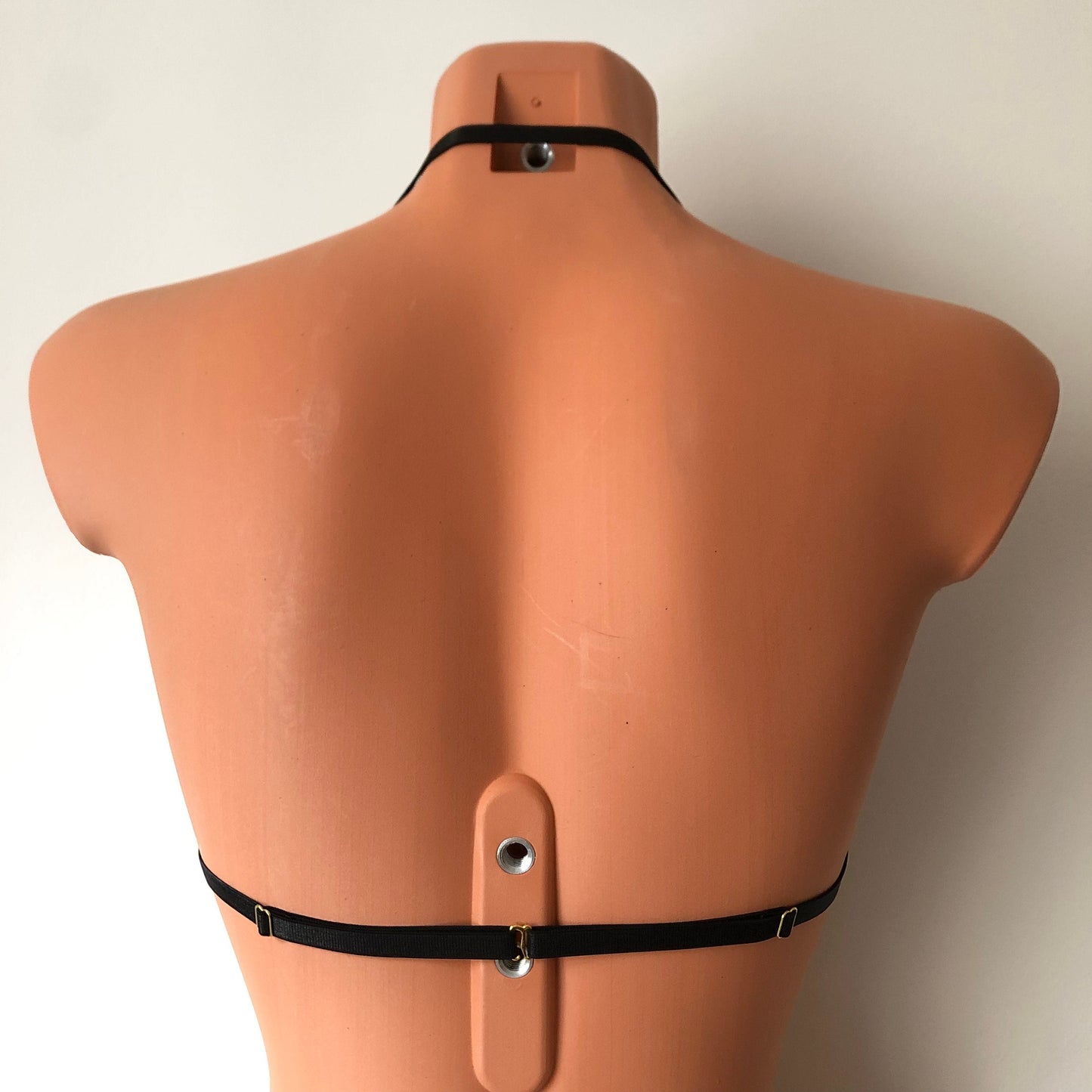 Black shimmy fringe draped halter bra on a mannequin - back