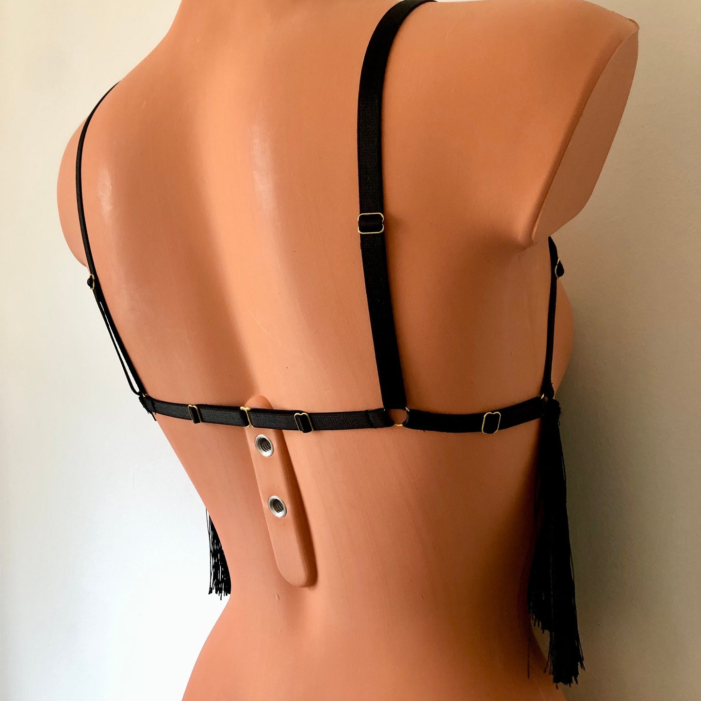Black shimmy fringe cupless bra on a mannequin - back diagonal