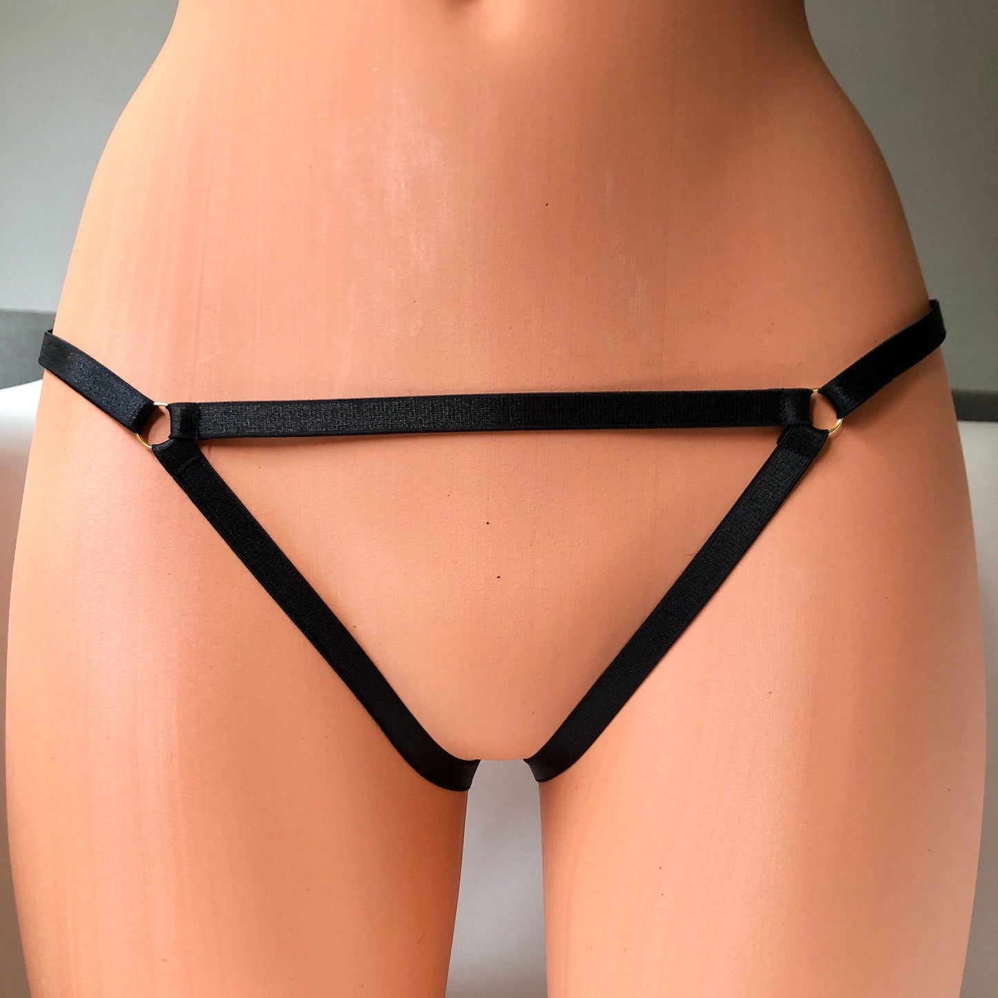 Elastic straps open panties on a mannequin - front