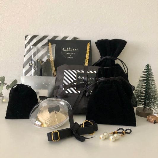 A collection of black velvet and black and white striped sachets, pouches and boxes