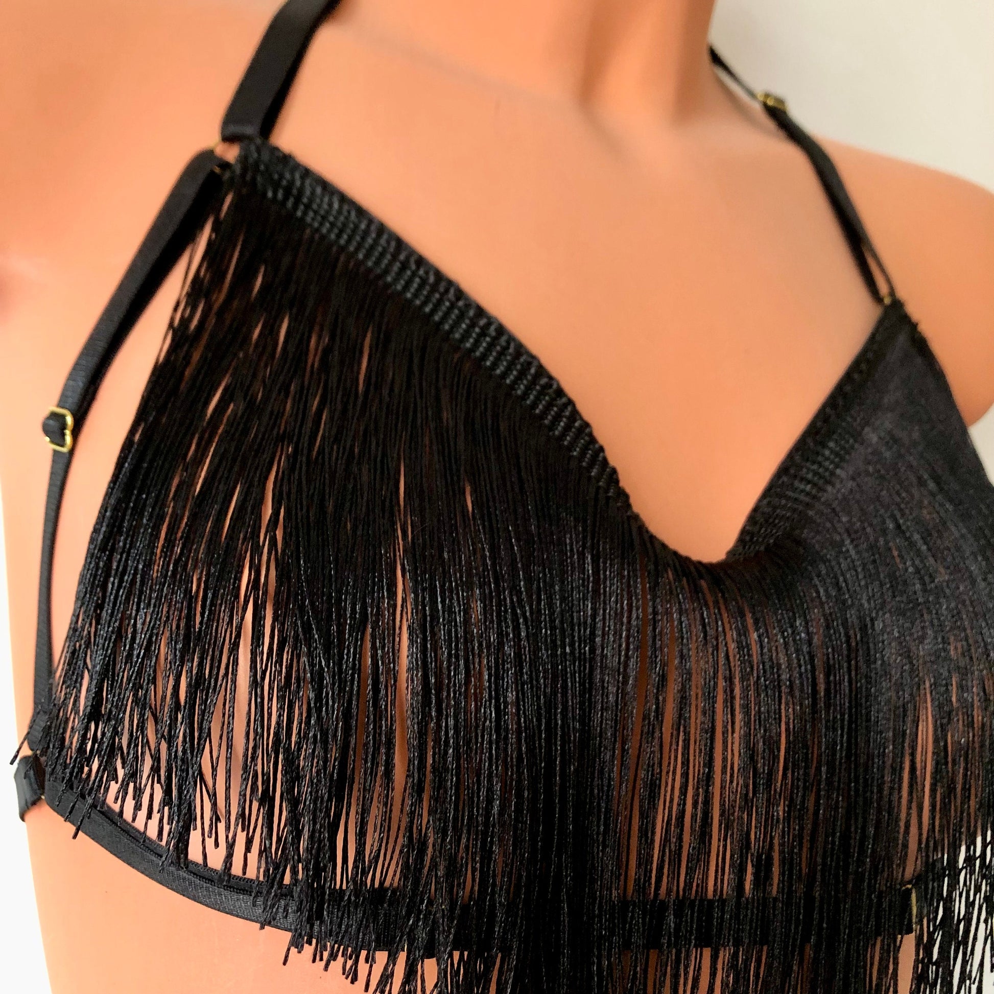 Black shimmy fringe draped halter bra on a mannequin - detail