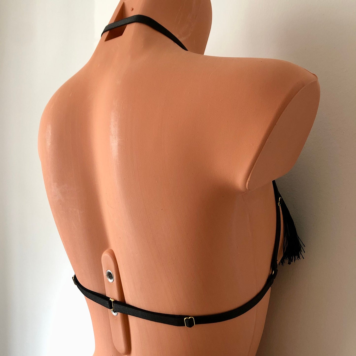 Black shimmy fringe draped halter bra on a mannequin - back diagonal