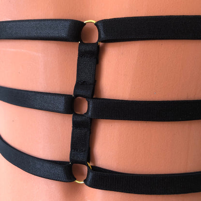 Black elastic waist cage harness on a mannequin - detail