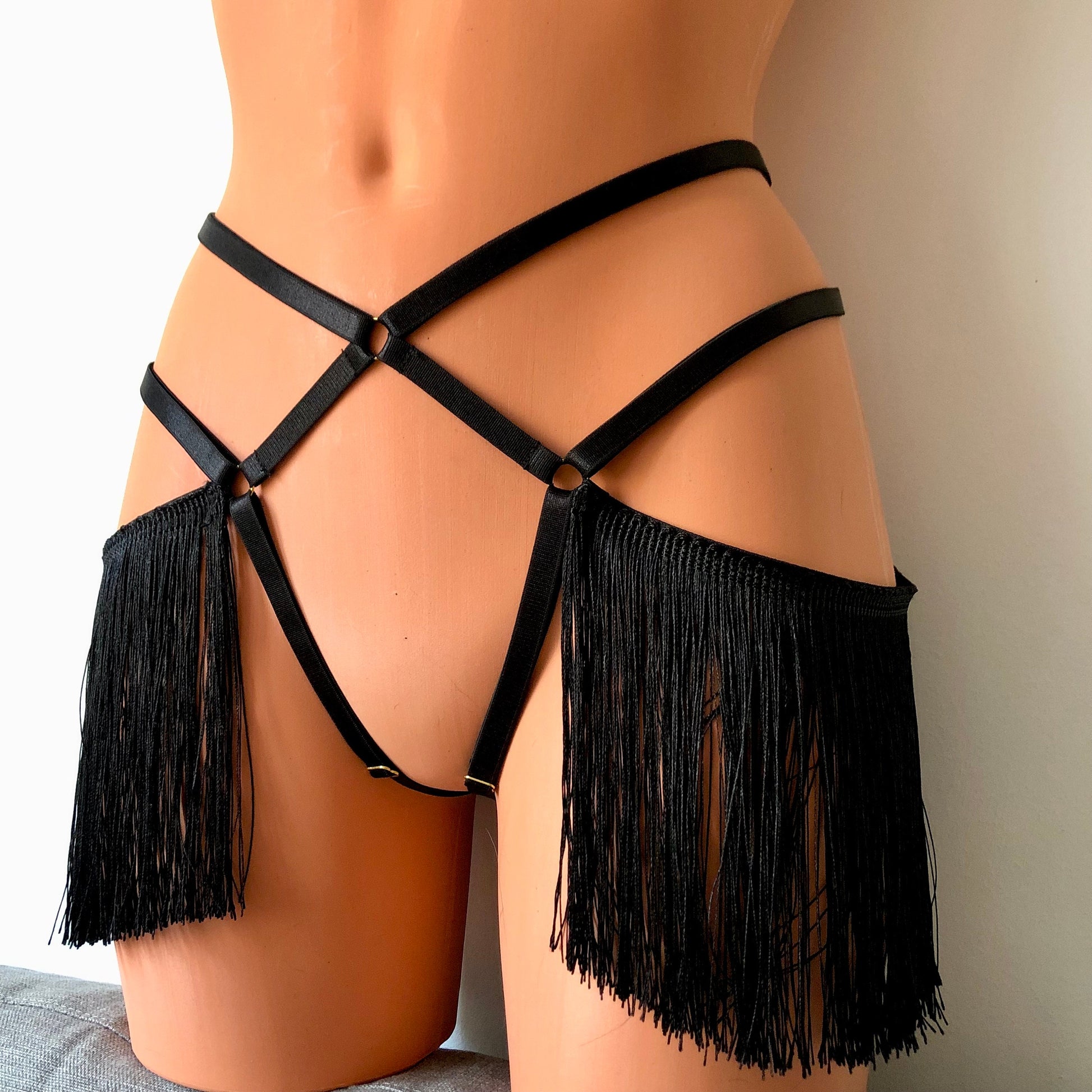 Black shimmy fringe open crotchless cage thong on a mannequin - front diagonal