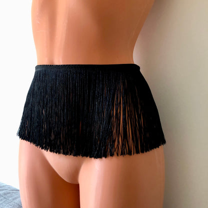 Black shimmy fringe belt skirt waist harness on a mannequin - front diagonal
