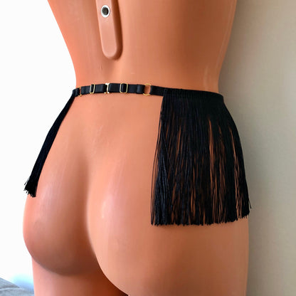 Black shimmy fringe belt skirt waist harness on a mannequin - back diagonal