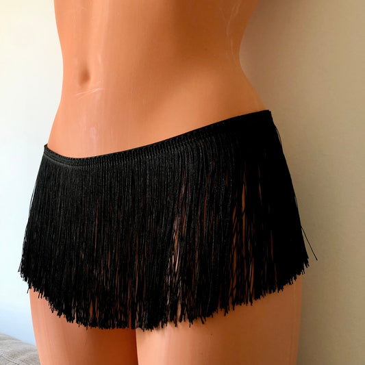 Black shimmy fringe hip harness belt skirt on a mannequin - front diagonal