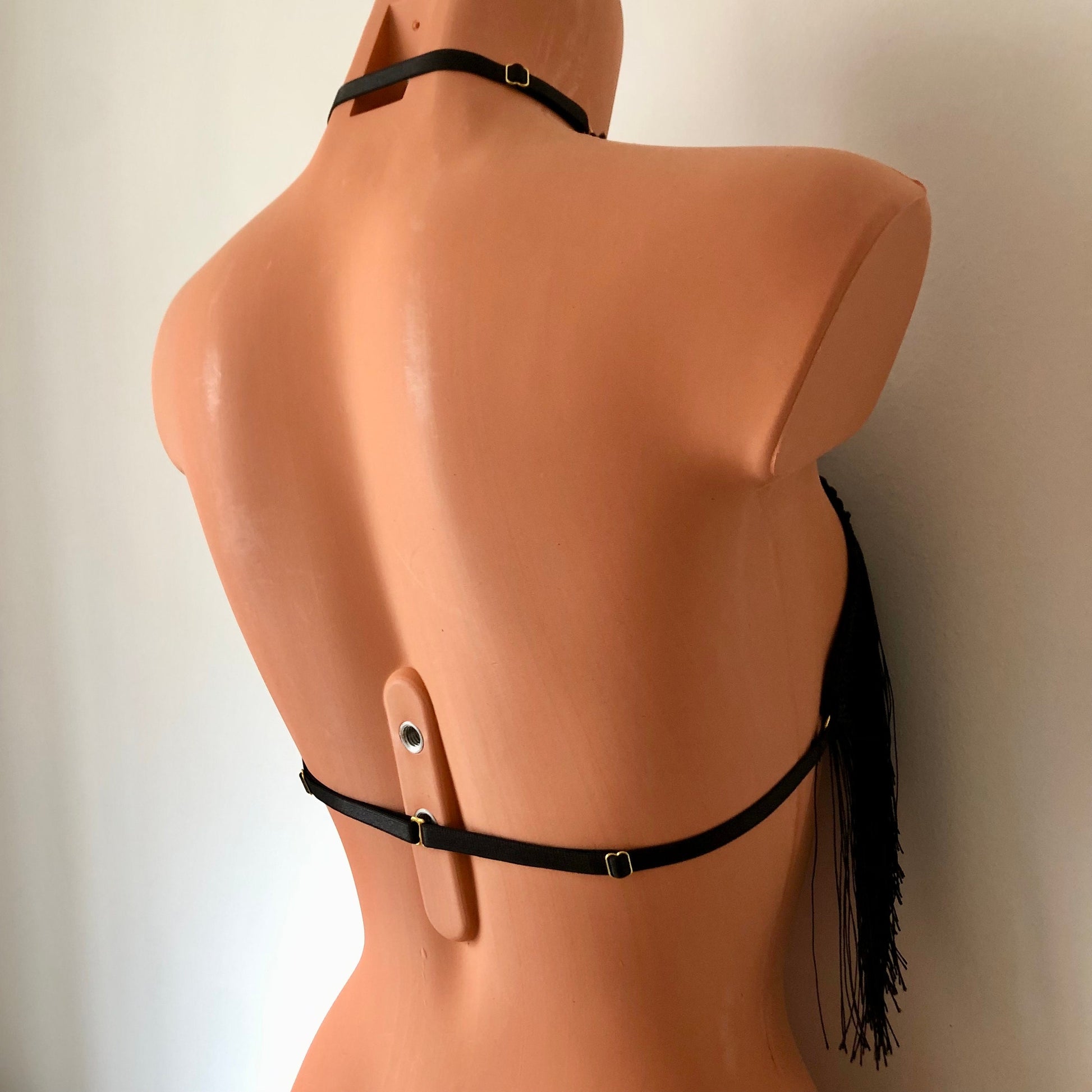 Black shimmy fringe twisted neck halter bra on a mannequin - back diagonal