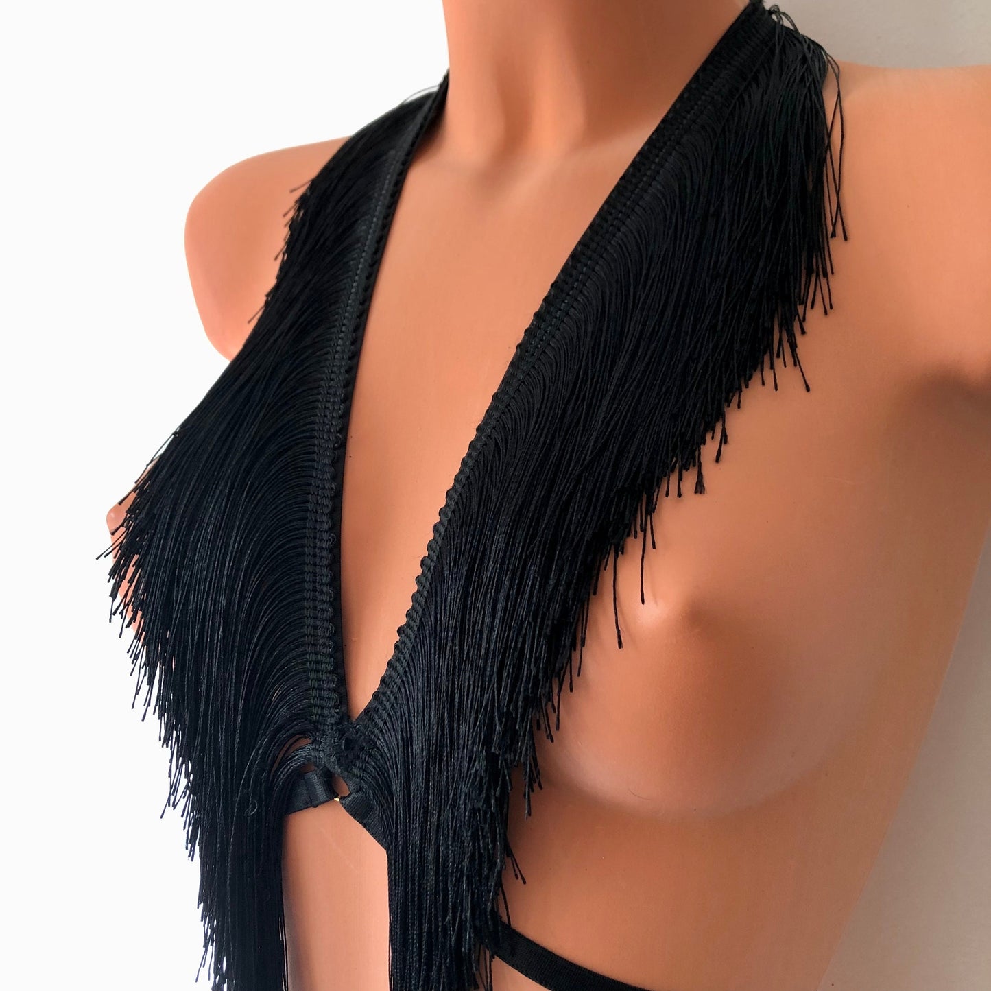 Black shimmy fringe chest harness on a mannequin - front diagonal