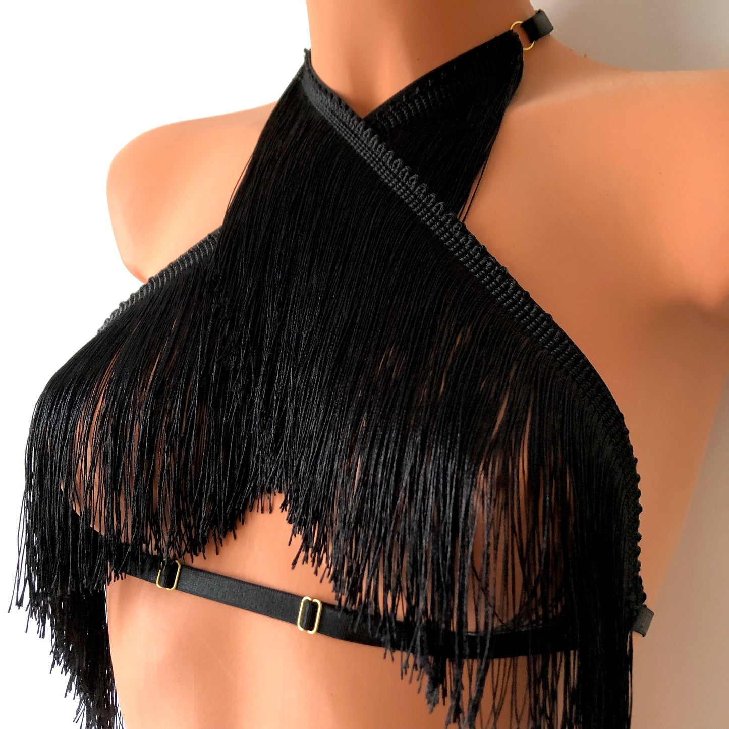 Black shimmy fringe twisted neck halter bra on a mannequin - front diagonal