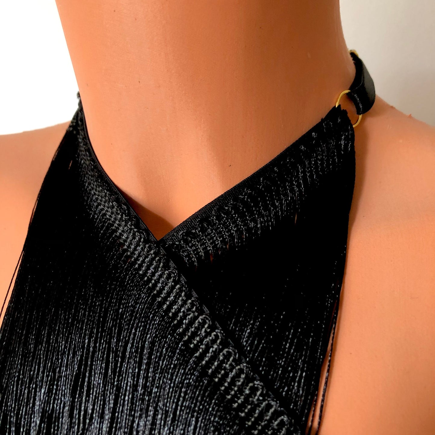 Black shimmy fringe twisted neck halter bra on a mannequin - detail